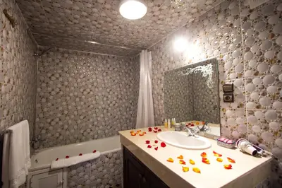 a bathroom with a sink and a bath tub at Riad Hala in Fès