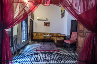 a living room with a couch and a table at Riad Hala in Fès