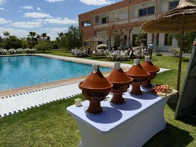 a buffet of food on a table next to a swimming pool at Domaine Bahi in Marrakech