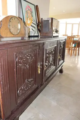 a wooden cabinet with a microwave on top of it at Bhalil Farm House in Sefrou