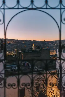 a view of a city from behind a fence at Riad Le Calife in Fès