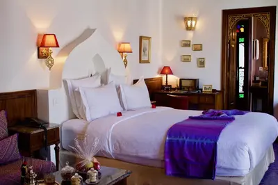 a bedroom with a large white bed in a room at Riad Le Calife in Fès