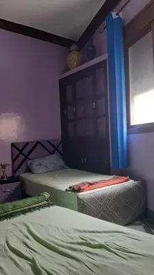 two twin beds in a room with a window at Mini Riad family Chez Adil Batha Fés in Fès