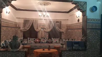 a living room with a couch and a tv at Mini Riad family Chez Adil Batha Fés in Fès