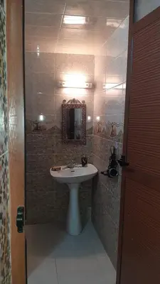 a bathroom with a sink and a mirror at Mini Riad family Chez Adil Batha Fés in Fès