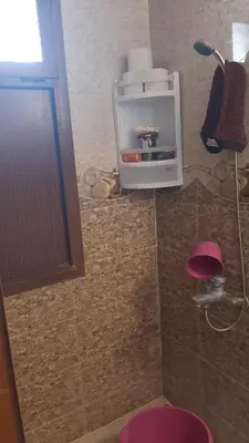 a bathroom with a toilet and a pink stool at Mini Riad family Chez Adil Batha Fés in Fès
