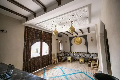 a living room with a large wooden door at Riad Jouba in Merzouga