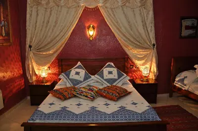 a bedroom with a bed with two pillows on it at Dar Aliane in Fès