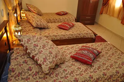 two beds with pillows in a hotel room at Dar Aliane in Fès
