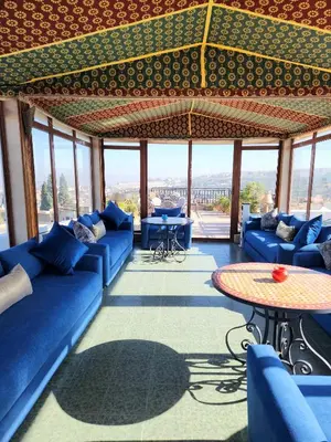a living room with blue couches and a table at Le Riad Palais d'hotes Suites & Spa Fes in Fès