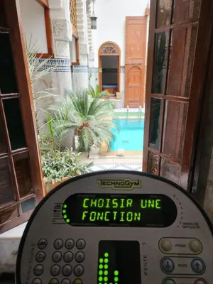 a remote control in front of a house with a pool at Le Riad Palais d'hotes Suites & Spa Fes in Fès