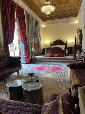 a large room with a bed and a couch at Le Riad Palais d'hotes Suites & Spa Fes in Fès
