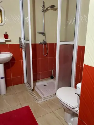 a bathroom with a shower and a toilet and a sink at Appartement chez Elmehdi in Fès