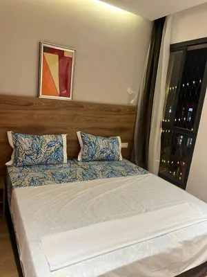 a bedroom with a large bed with blue pillows at Hotel beaux arts in Meknès