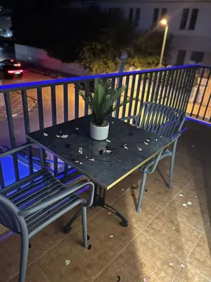 a table with a potted plant on a balcony at Hotel beaux arts in Meknès