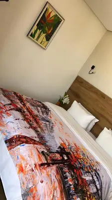 a bed with a colorful blanket on top of it at Hotel beaux arts in Meknès