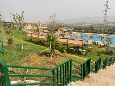 a view of a resort with a pool and a train at Hotel beaux arts in Meknès