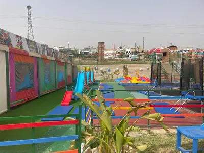 a playground with colorful play equipment in a park at Hotel beaux arts in Meknès