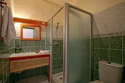 a bathroom with a shower and a sink and a toilet at Kasbah Sirocco in Zagora