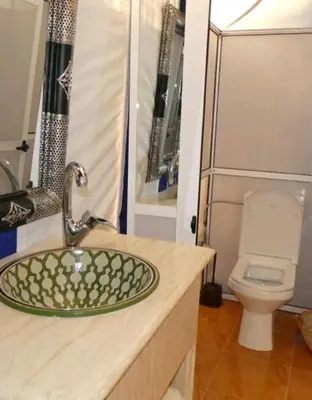 a bathroom with a sink and a toilet at Merzouga Sahara Camp in Merzouga