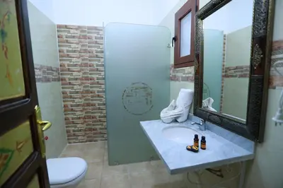a bathroom with a sink and a mirror at Kasbah Tizimi in Erfoud