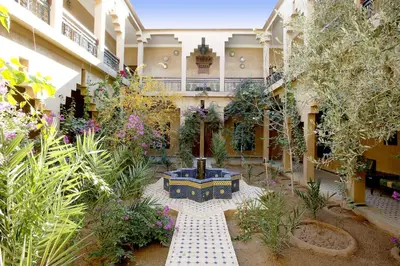 a courtyard with a fountain in the middle of a building at Kasbah Tizimi in Erfoud