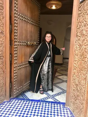 a woman standing in front of a door at Riad Dar Laura in Fès