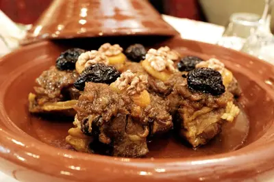 a plate of food with cookies and fruit on it at Riad Dar Laura in Fès
