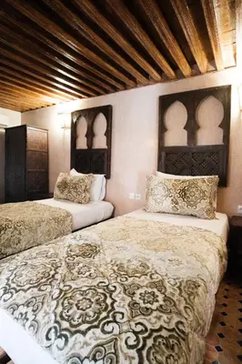 a bedroom with two beds and two pillows at Riad Dar Laura in Fès