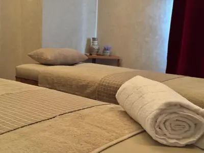 two beds with a rolled up towel on them at Riad Dar Laura in Fès