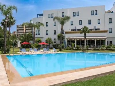 a large swimming pool in front of a hotel at Ibis Fes in Fès