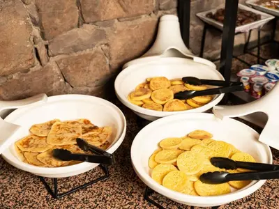 three bowls filled with cookies and tongs on a table at Ibis Ouarzazate Centre in Ouarzazate