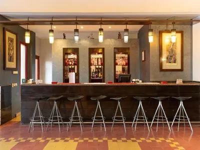 a bar in a restaurant with stools at Ibis Ouarzazate Centre in Ouarzazate