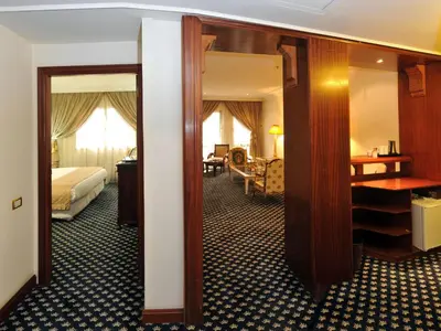 a hotel room with a bed and a mirror at Ramada By Wyndham Fes in Fès