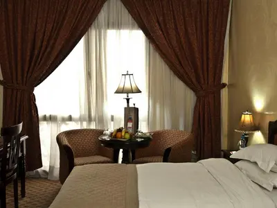 a hotel room with a bed and a table with fruit on it at Ramada By Wyndham Fes in Fès