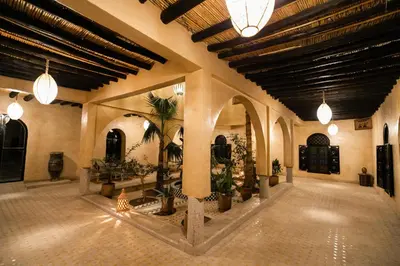 a large lobby with potted plants in a building at Kasbah Mohayut in Merzouga