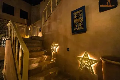 two stars on the wall next to a staircase at Kasbah Mohayut in Merzouga