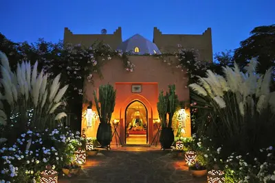 a house with an entry way with flowers and plants at Riad Al Mendili Private Resort & Spa in Had Abdallah Rhiat