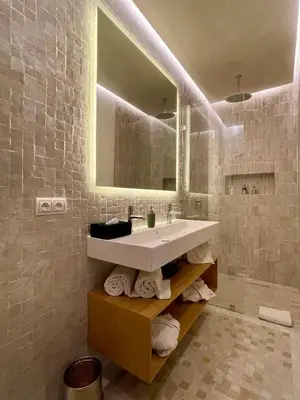 a bathroom with a sink and a mirror at Riad Zamane Fès - Boutique & Spa in Fès