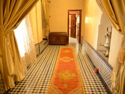 a hallway of a house with a rug on the floor at Riad El Yacout in Fès