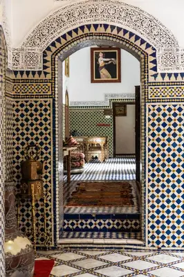 an archway in a room with blue and white tiles at Riad El Yacout in Fès