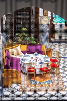a painting of a living room with a table and chairs at Riad El Yacout in Fès