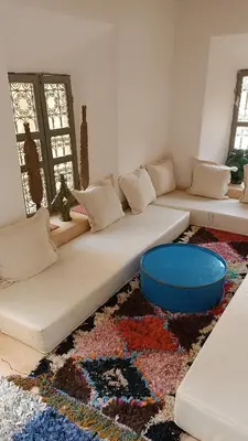 a white couch in a living room with a rug at Kasbah ait Moussa in Kalaat MGouna