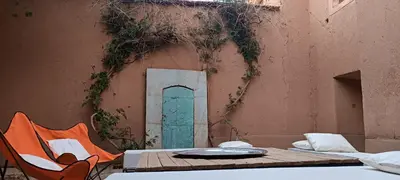 a table and chairs in front of a building at Kasbah ait Moussa in Kalaat MGouna