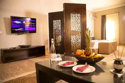 a living room with a table with a bowl of fruit at Palais Du Desert Hotel & Spa in Erfoud