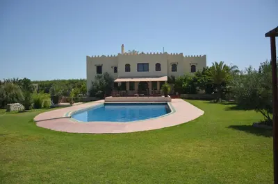 a house with a swimming pool in the yard at Riad le Ksar de Fes in Ain Cheggag