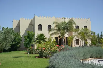 a building with a garden in front of it at Riad le Ksar de Fes in Ain Cheggag