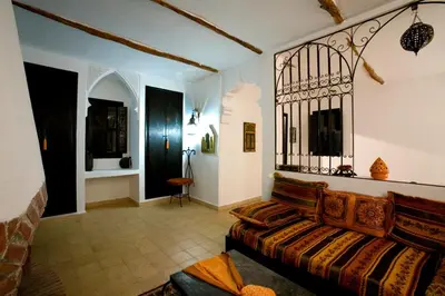 a living room with a couch in a room at Riad le Ksar de Fes in Ain Cheggag