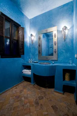 a blue bathroom with a sink and a mirror at Riad le Ksar de Fes in Ain Cheggag
