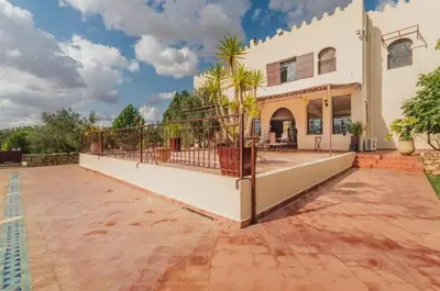 an exterior view of a house with a patio at Riad le Ksar de Fes in Ain Cheggag